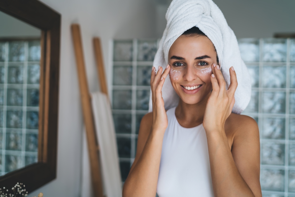Young smiling female with towel on head